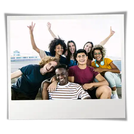 Group of racially diverse teens sitting together on steps and having fun.