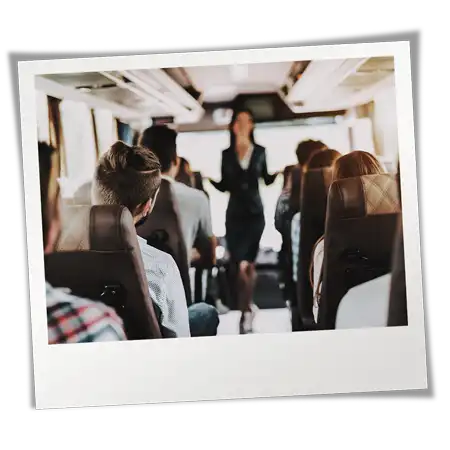 Lady speaking with people in seats who are on their way to services.